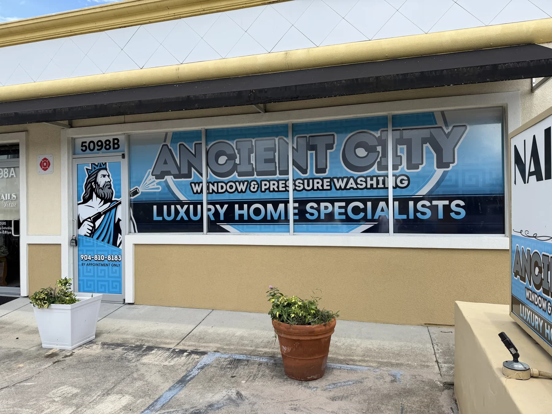 Ancient City Window and Pressure Washing storefront graphics installed by Luna Labs