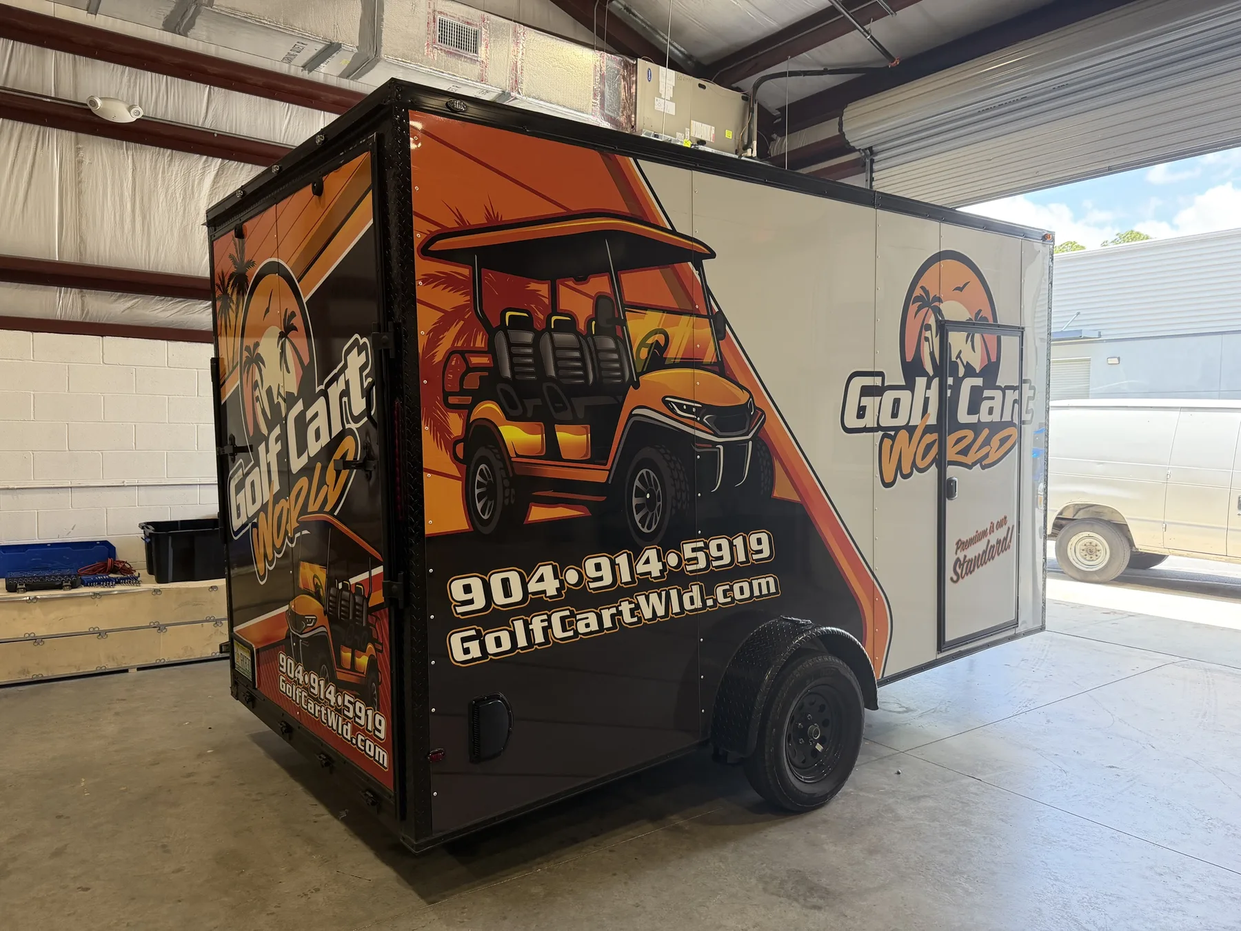 Golf Cart World orange commercial trailer wrap shown from the side